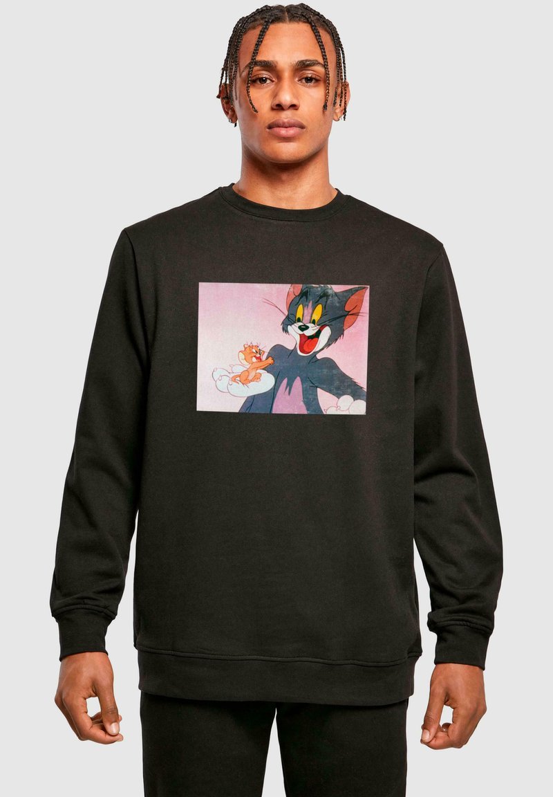 Black sweatshirt with a cartoon print of Tom and Jerry. Features a crew neck and long sleeves, made of a soft knit material.
