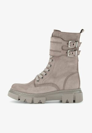 Gray suede ankle boot with a round toe, flat rubber sole, lace-up front, and two decorative buckles at the top of the shaft.