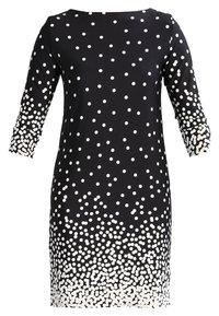 Schwarzes Kleid mit Dreiviertelärmel, das ein gepunktetes Muster in Weiß aufweist, das zum Saum hin verblasst. Glatter Stoff mit einer figurbetonten Silhouette.