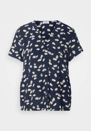 Blouse marine à manches courtes, col en V, ornée d'un imprimé de marguerites en blanc et jaune. Fabriquée dans un tissu doux avec une coupe décontractée.