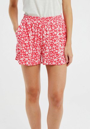 Rote Blumen-Shorts mit elastischem Bund, ausgestattet mit weißen Blumen und kleinen Blättern sowie Seitentaschen. Leichter Stoff mit glatter Textur.