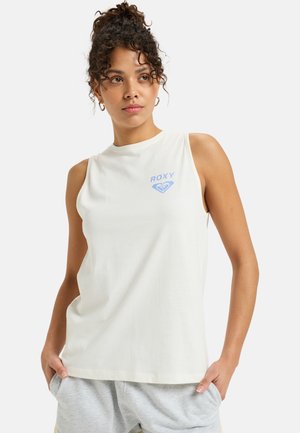 Sleeveless cream tank top featuring a blue "ROXY" logo and a heart graphic. Made from soft cotton, it has a relaxed fit and smooth texture.