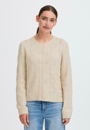 Light beige cardigan with a textured knit pattern, featuring a round neckline, seven buttons down the front, and ribbed cuffs.
