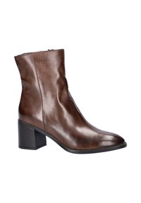 Bottines en cuir marron avec une finition lisse, un bout légèrement effilé et un talon large. Présente une fermeture éclair sur le côté.