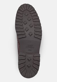 Sole di scarpa marrone con motivi di presa testurizzati. Presenta in modo prominente il nome del marchio "HENRY STEVENS" e "GOMOSO LIGHT" sulla base.