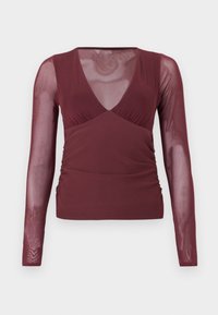 Μπλούζα μακρυμάνικη σε μπορντό χρώμα με διαφανείς φούτερ μανίκια και V-λαιμόκοψη, με ραβδώσεις στις πλευρές και σώμα από αδιαφανές ύφασμα.