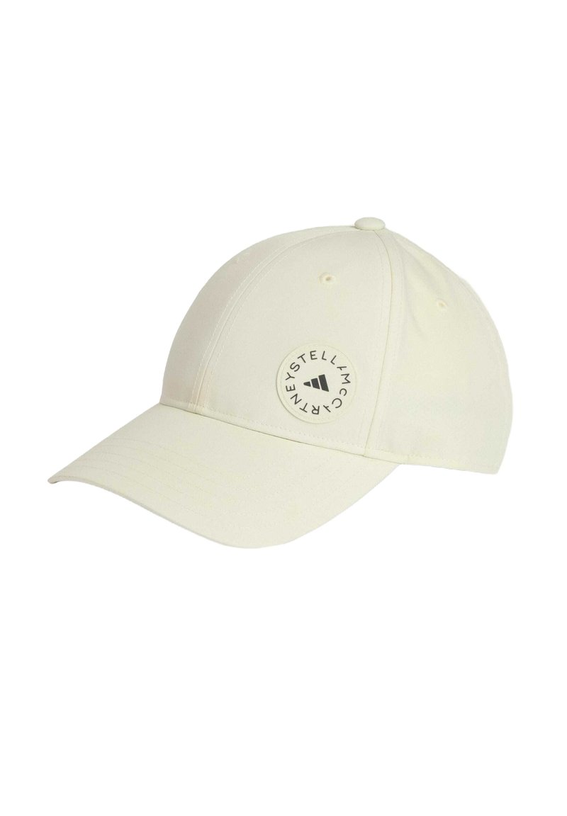 White baseball cap in soft fabric with a curved peak, featuring a circular logo patch on the side and six ventilation eyelets.
