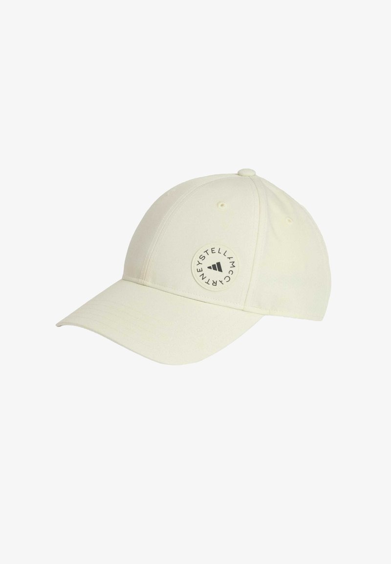 White baseball cap in soft fabric with a curved peak, featuring a circular logo patch on the side and six ventilation eyelets.