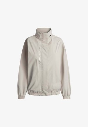 Helle beige Windbreaker-Jacke mit hohem Kragen, elastischen Bündchen und zwei Seitentaschen. Verfügt über reflektierenden Text und ein minimalistisches Design.