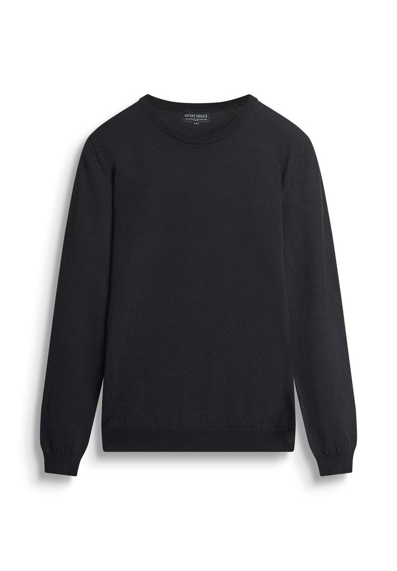 Maglione nero realizzato in un tessuto a maglia liscio. Presenta un classico scollo rotondo, maniche lunghe e polsini e orlo a coste.