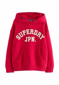 Červená mikina z bavlny s přední kapsou, elastickými manžetami a lemem, na kterých je v krémovém písmu vytištěno "SUPERDRY JPN."