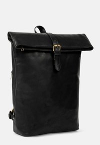 Black leather backpack with a roll-top closure, gold hardware accents, a single top handle, and a side zipper pocket. Smooth texture.
