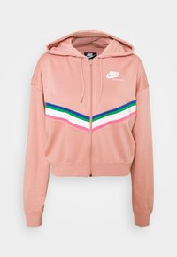 Nike zip-hoodie i mjukt persikofärgat tyg. Har en färgblockdesign med gröna, blå, rosa och vita ränder. Inkluderar justerbar huva.