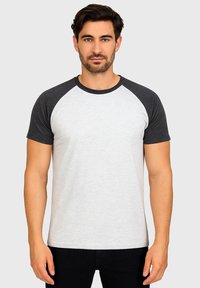 Gray and white short-sleeve t-shirt with raglan sleeves, round neckline, and a smooth texture, displayed on a male model against a plain background.