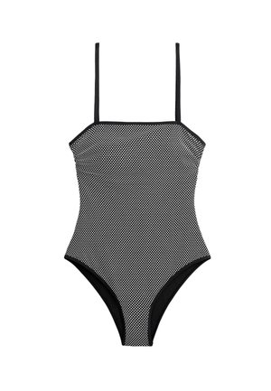 Schwarz-weiß gepunkteter Einteiler mit dünnen Trägern und einem geraden Ausschnitt vor weißem Hintergrund.