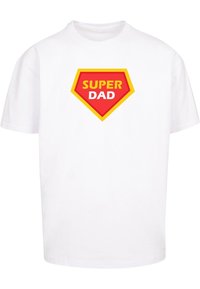 White cotton t-shirt featuring a bold red and yellow "SUPER DAD" graphic within a red and yellow shield shape on the front.