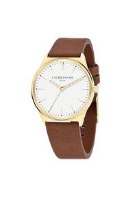 Montre analogique ronde avec un cadran blanc, un boîtier doré et un bracelet en cuir marron. Présente des repères horaires et des aiguilles minimalistes.