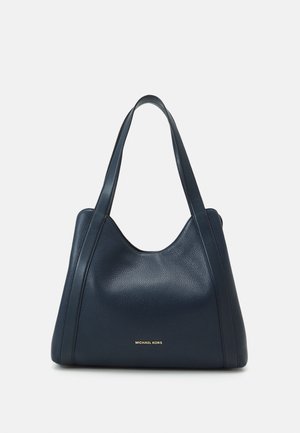 Granatowa skórzana torba typu tote z podwójnymi paskami na ramię oraz logo „Michael Kors” w złotych literach na środku z przodu.