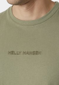 Helly Hansen CORE - Triko s potiskem - lav green