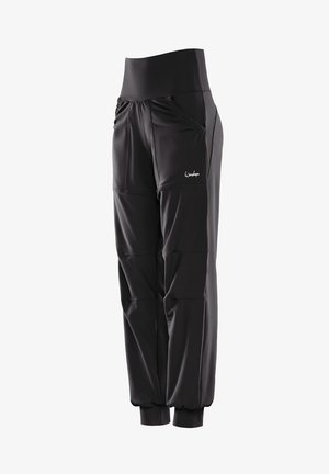 Black athletic pants made of stretch fabric, featuring a high waistband, zippered pockets, and gathered ankle cuffs for a tapered shape.