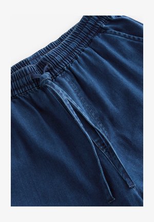 Marinblå bomullsshorts med elastisk midja, dragsko och subtilt texturerad tyg. Har horisontell ribbing och förstärka sömmar.