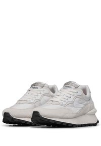 Weiße Sneaker mit einer Mischung aus glattem und Wildledertexturen, ausgestattet mit einer gepolsterten Zunge, Schnürverschluss und einer strukturierten schwarzen Gummisohle.