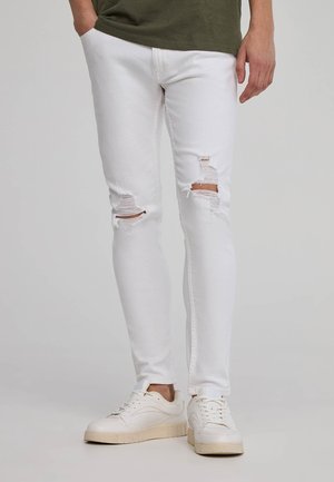 CON STRAPPI - Jeans slim fit - bianco