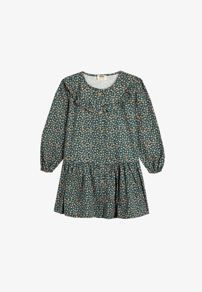 Blomstret kjole med en mørkegrøn baggrund og små pink og hvide blomster, lange ærmer, en flæsekrave og knaplukning foran.