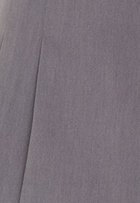 Paarse stof met een gladde textuur en fijne diagonale weving. Heeft een zichtbare naad en een subtiele glans. Geschikt voor kleding of bekleding.