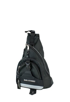 Black sling backpack with multiple zippered compartments, adjustable strap, and soft material. Features reflective accents and branding detail.