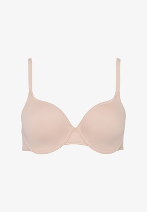 Beige underwire bra with smooth, molded cups, adjustable straps, and a simple, seamless design. Features a delicate stitching detail.