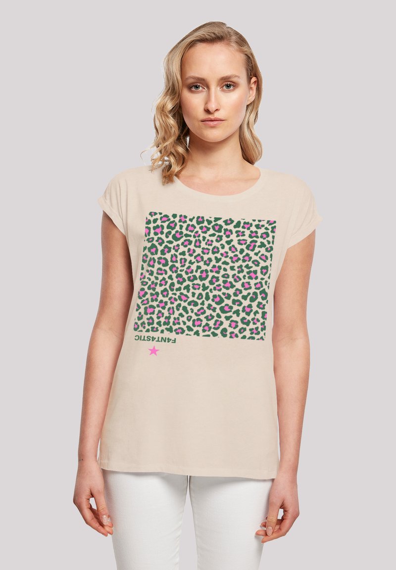 Beige short-sleeve t-shirt featuring a green leopard print design with pink accents, and the word "FANTASTIC" in black at the bottom.