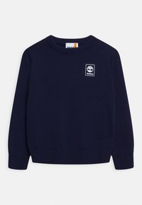 Jersey de punto azul marino con cuello redondo, puños y bajo de canalé, que presenta un parche con el logo blanco de Timberland en el pecho.