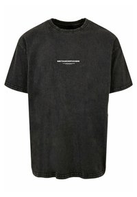 Sort bomulds t-shirt med korte ærmer og rund hals, prydet med "METAMORPHOSIS" trykt i hvid på forsiden. Slidt tekstur.