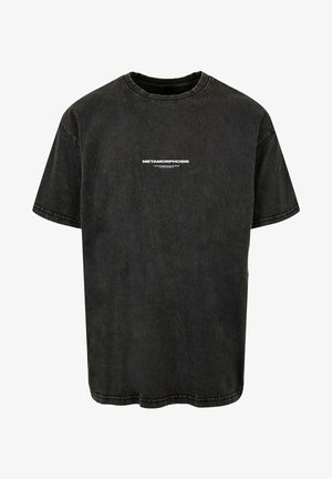 Sort bomulds t-shirt med korte ærmer og rund hals, prydet med "METAMORPHOSIS" trykt i hvid på forsiden. Slidt tekstur.