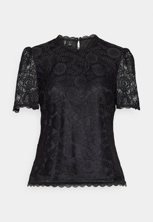 Svart blonde topp med korte pufferm, rund halslinje og bølgekant. Intrikate blomsterdesign dekker stoffet. Glidelås bak.