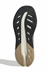Suola di scarpa atletica dal design nero e beige, gomma strutturata per una migliore aderenza, con scanalature direzionali e aperture per la ventilazione.