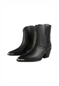 Bottines en cuir noir avec des pointes effilées, des talons bas empilés et des accents argentés au niveau des orteils. Texture lisse et détails de couture simples.