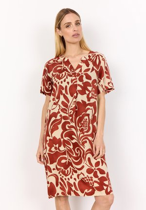 Short, beige dress with a floral pattern in dark red. Features a V-neckline, short sleeves, and a relaxed fit. Smooth fabric texture.