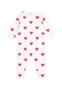 Tutina bianca con maniche lunghe, caratterizzata da un motivo a cuori rossi su tutta la superficie. Tessuto morbido, scollatura rotonda e design con piedi.