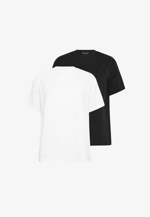 T-shirts unis à manches courtes et col rond en noir et blanc, présentés superposés sur un fond blanc.