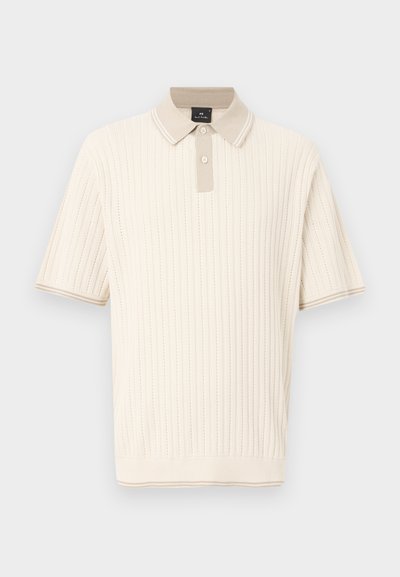 Polo en maille à manches courtes crème avec côtes verticales, deux boutons, col beige et bordures assorties aux poignets et à l'ourlet.