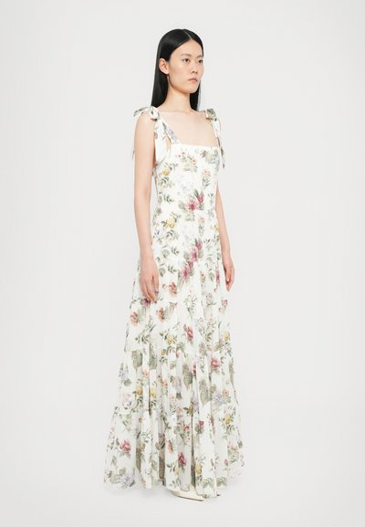 Floral maxi dress with a square neckline, sleeveless design, and shoulder ties. White fabric features assorted pastel floral patterns and ruffles.