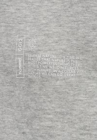 Grauer Baumwollstoff mit glatter Textur, der weißen Text und Grafiken zeigt. Der Text enthält ein motivierendes Zitat über die Natur.