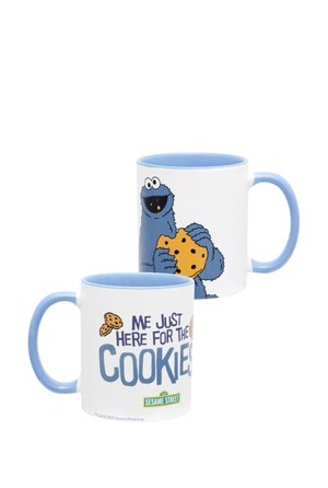 White mug with blue handle and interior featuring Cookie Monster holding a cookie and text "Me just here for the cookies" from Sesame Street.