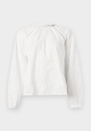 Blouse blanche à manches longues avec broderie florale subtile, encolure froncée et poignets élastiques sur les manches.