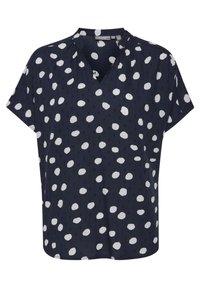 Navy blue blouse with white polka dots, short sleeves, V-neck, and gathered detailing at the shoulders, made from lightweight fabric.
