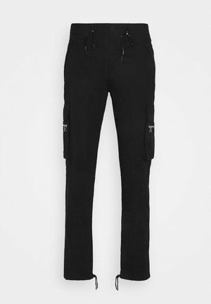 Pantalon cargo noir avec poches avant, poches latérales zippées, taille à cordon de serrage et cordons ajustables au niveau des coutures des chevilles.
