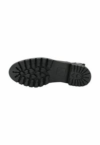 Suela de bota de goma negra con profundos canales multidireccionales para tracción. Presenta una textura suave y un logo de marca estampado.