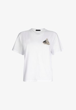T-shirt bianco in cotone con collo rotondo e maniche corte, caratterizzato da un design decorativo di una barca con accenti neri e strass sul petto.